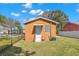 Rear view of house with fenced yard and central air unit at 6103 Anna Ave, Gibsonton, FL 33534
