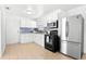 An updated kitchen featuring white cabinets and stainless steel appliances at 6103 Anna Ave, Gibsonton, FL 33534