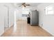 Bright living room leading into kitchen, featuring neutral tile and ample light at 6103 Anna Ave, Gibsonton, FL 33534