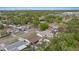 This aerial view shows a neighborhood with tree-lined streets and well-maintained homes under a blue sky at 6339 S Lansdale Cir, Tampa, FL 33616