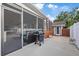 Outdoor space featuring a screened porch, grill, fenced yard and storage shed at 6339 S Lansdale Cir, Tampa, FL 33616
