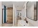 Bright bathroom featuring a walk-in shower with decorative wood and tile accents, and updated fixtures at 6339 S Lansdale Cir, Tampa, FL 33616