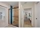 Stylish bathroom boasts a glass-enclosed shower with unique tile design and a view into the connected bedroom at 6339 S Lansdale Cir, Tampa, FL 33616