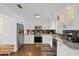Modern kitchen features stainless appliances, stone countertops, and decorative tile backsplash at 6339 S Lansdale Cir, Tampa, FL 33616