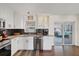 Modern kitchen with stainless appliances and stone countertops with access to an outdoor seating area at 6339 S Lansdale Cir, Tampa, FL 33616