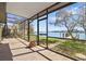 Enclosed lanai with waterfront views, providing an idyllic setting for relaxation and entertainment at 649 79Th S Cir, St Petersburg, FL 33707