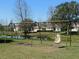 Neighborhood swing set near a pond with a house visible in the background at 6519 Sparkling Way, Wesley Chapel, FL 33545