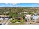 Stunning aerial view of the neighborhood showcasing the skyline, mature trees, and colorful houses at 681 Jasmine S Way, St Petersburg, FL 33705