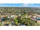 Beautiful aerial view of the home and neighborhood showcasing mature trees, lush greenery, and nearby houses at 681 Jasmine S Way, St Petersburg, FL 33705