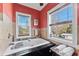 Elegant bathroom with a black trimmed tub under a window and two windows for natural light at 681 Jasmine S Way, St Petersburg, FL 33705