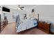 Bedroom with large bed, two nightstands, window, and ceiling fan at 681 Jasmine S Way, St Petersburg, FL 33705