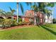 Charming two-story home with mature landscaping and inviting walkway to the front door at 681 Jasmine S Way, St Petersburg, FL 33705