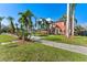 Charming two-story home with mature landscaping and inviting walkway to the front door at 681 Jasmine S Way, St Petersburg, FL 33705