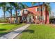 Charming two-story home with mature landscaping and inviting walkway to the front door at 681 Jasmine S Way, St Petersburg, FL 33705