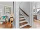 Hallway with staircase connecting to other rooms, featuring hardwood floors and white walls at 681 Jasmine S Way, St Petersburg, FL 33705