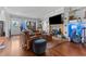 Cozy living room with hardwood floors, fireplace, and leather furniture, ideal for relaxation at 681 Jasmine S Way, St Petersburg, FL 33705