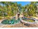 A freeform pool with spa and rock grotto features in a lush tropical backyard at 681 Jasmine S Way, St Petersburg, FL 33705