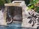 Close-up view of the stunning rock waterfall feature in the pool area at 681 Jasmine S Way, St Petersburg, FL 33705