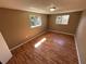 Cozy bedroom featuring laminate floors, neutral-colored walls, and two windows for natural light at 7116 Sandalwood Dr, Port Richey, FL 34668