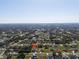 An aerial view of a residential neighborhood shows rooftops, and roads stretching to the distant horizon, with trees in between at 7235 Peacock Ln, Englewood, FL 34224
