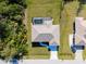 Aerial view of the house with its backyard pool, a pristine driveway, and a well maintained lawn at 7235 Peacock Ln, Englewood, FL 34224