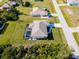 Aerial view of the property with its private screened-in pool, well-manicured lawn, and convenient street access at 7235 Peacock Ln, Englewood, FL 34224