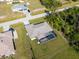 Aerial view of a home featuring a screened-in pool, manicured lawn, and easy access to the neighborhood streets at 7235 Peacock Ln, Englewood, FL 34224