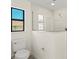 Bathroom featuring glass enclosed shower, blue window, and white sink at 7235 Peacock Ln, Englewood, FL 34224