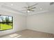 Bedroom featuring a trey ceiling, ceiling fan, and a window overlooking the front yard at 7235 Peacock Ln, Englewood, FL 34224