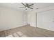 Spacious bedroom featuring wood-look floors, a ceiling fan, and ensuite bathroom access at 7235 Peacock Ln, Englewood, FL 34224