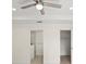 Well lit primary bedroom features neutral walls, a ceiling fan, and doorways to the bathroom and closet at 7235 Peacock Ln, Englewood, FL 34224