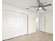 Bedroom featuring wood-look floors, ceiling fan, and a closet with sliding doors at 7235 Peacock Ln, Englewood, FL 34224