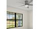 Bedroom view showcasing a modern ceiling fan and a window overlooking the outdoors at 7235 Peacock Ln, Englewood, FL 34224