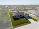 An exterior perspective of the house showcasing the verdant lawn, lengthy driveway, and attractive landscaping at 7235 Peacock Ln, Englewood, FL 34224