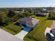 External view showing the green yard, spacious driveway, and proximity to nearby residential properties at 7235 Peacock Ln, Englewood, FL 34224