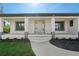 Inviting front porch with decorative columns and large windows at 7235 Peacock Ln, Englewood, FL 34224