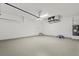 Spacious garage with painted floors and walls, overhead door, and ample room for vehicles and storage at 7235 Peacock Ln, Englewood, FL 34224