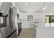 Kitchen boasts stainless appliances, white cabinets, and eat-in area at 7235 Peacock Ln, Englewood, FL 34224