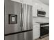 Stainless appliances and white cabinets provide a clean, modern kitchen at 7235 Peacock Ln, Englewood, FL 34224