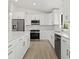 Bright kitchen featuring stainless appliances, white cabinets, and modern countertops at 7235 Peacock Ln, Englewood, FL 34224