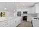 Open concept kitchen with stainless appliances, pendant lights, and center island at 7235 Peacock Ln, Englewood, FL 34224