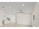 Bright living room features tile flooring, a modern ceiling fan, and recessed lighting at 7235 Peacock Ln, Englewood, FL 34224