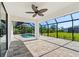 Paver patio leading to a screened-in pool area with lush landscaping at 7235 Peacock Ln, Englewood, FL 34224