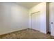 Bedroom featuring carpet, neutral paint, an open door, and a closet with bi-fold doors at 869 Vino Verde Cir, Brandon, FL 33511