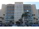 Towering exterior view of the condo building featuring multiple floors and balconies at 880 Mandalay Ave # C412, Clearwater Beach, FL 33767