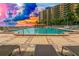 Exterior pool view featuring lounge chairs and access to the residences at 880 Mandalay Ave # C412, Clearwater Beach, FL 33767