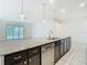 Kitchen island with granite countertop, stainless steel dishwasher, and pendant lighting at 9820 Monaghan St, Thonotosassa, FL 33592