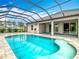 Stunning screened pool with a spa, surrounded by tile and a spacious patio, perfect for outdoor relaxation and entertainment at 9820 Monaghan St, Thonotosassa, FL 33592