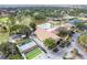 Aerial view of community clubhouse with a pool, sports courts, and ample parking at 2297 Lark E Cir # E, Palm Harbor, FL 34684