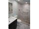 Remodeled bathroom features a sleek vanity and a luxurious, tiled walk-in shower at 2297 Lark E Cir # E, Palm Harbor, FL 34684